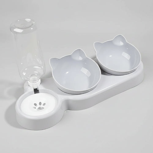 Pet water fountain with two ceramic bowls shaped like cats on a beige background