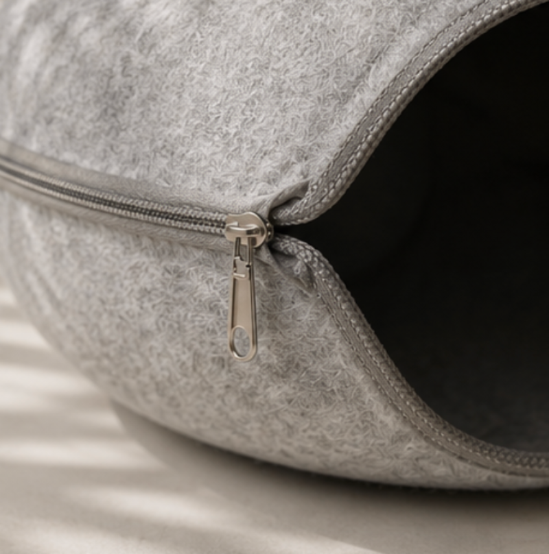Gray pet bed with a zipper on a light background