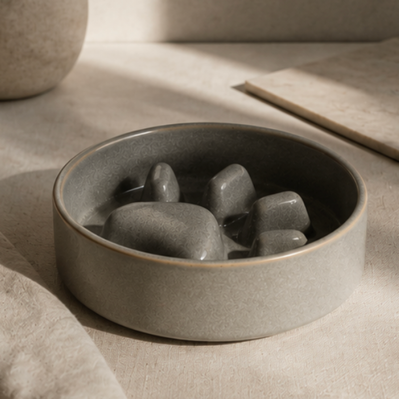 Ceramic bowl with stones on a neutral background