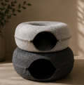 Premium felt donut cat cave bed in light and dark grey styled in a modern interior.
