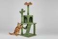 Two cats playing on a green cat tree with a window in the background